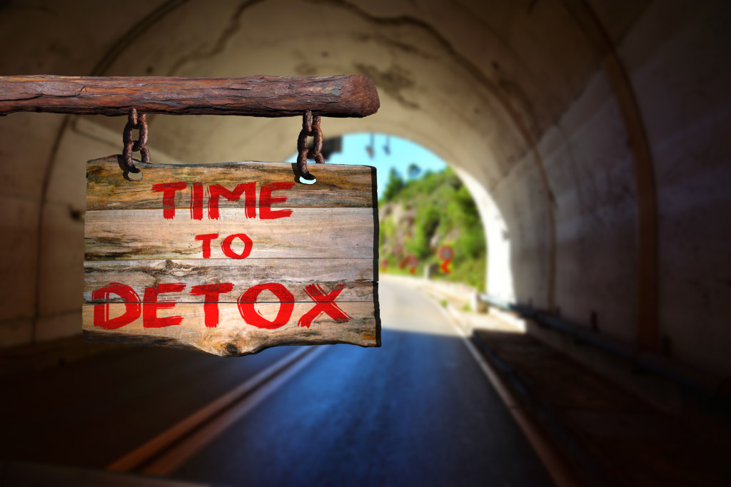 Time to detox motivational phrase sign on old wood with blurred background